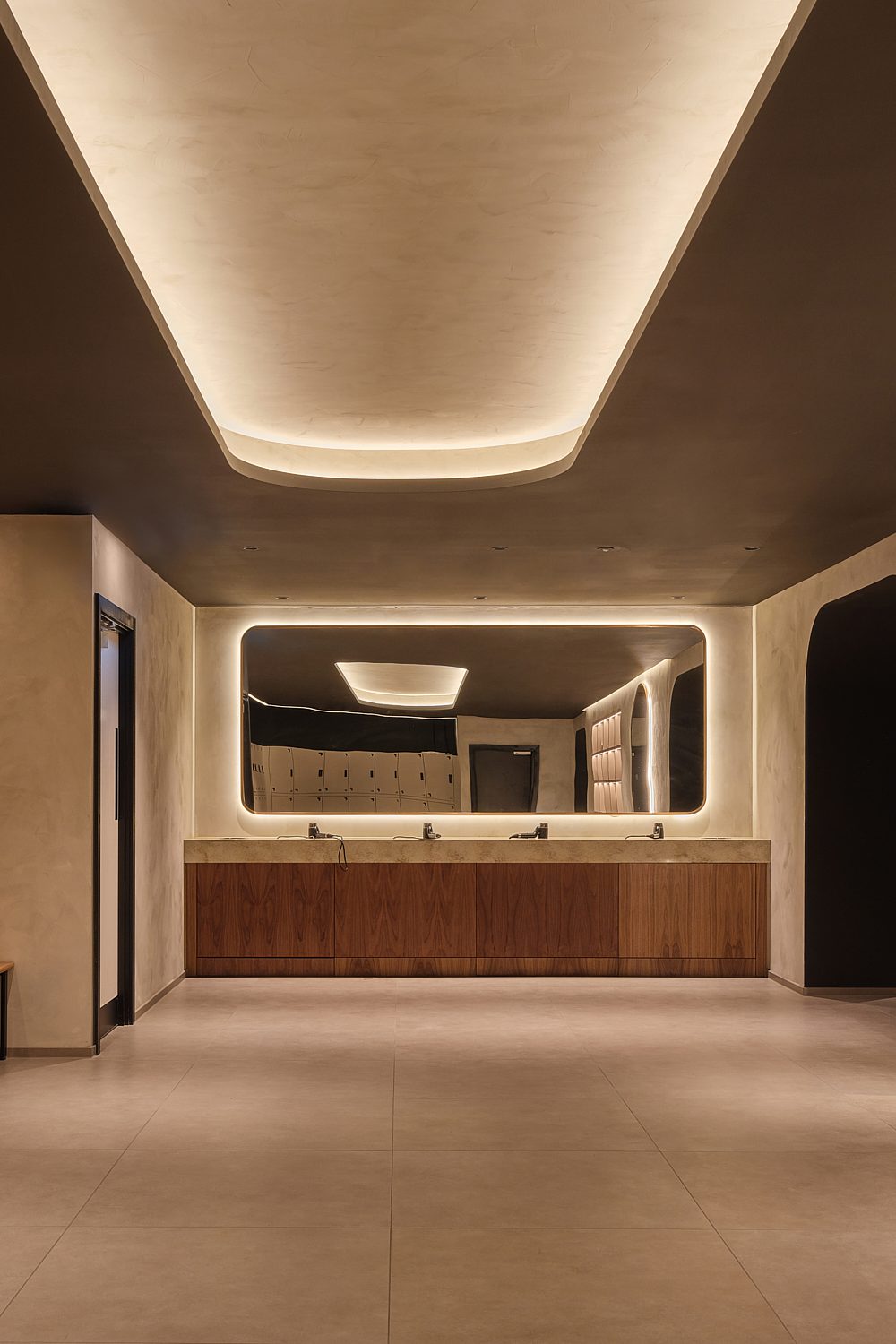 Changing room at Padium Cardiff featuring modern lockers and benches, photographed by Jon Green.
