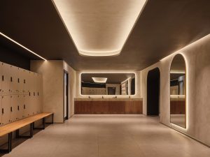 Changing room at Padium Cardiff featuring modern lockers and benches, photographed by Jon Green.