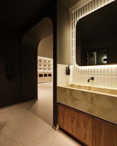 Changing room at Padium Cardiff featuring modern lockers and benches, photographed by Jon Green.